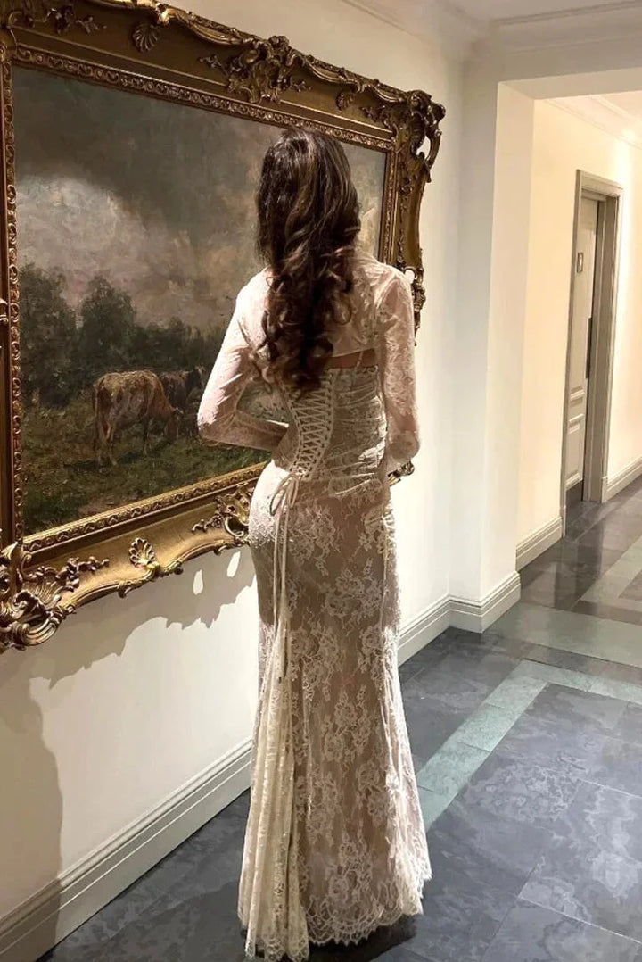 White fitted lace dress with sheer sleeves, elegant and feminine design with intricate lace detailing, perfect for special…