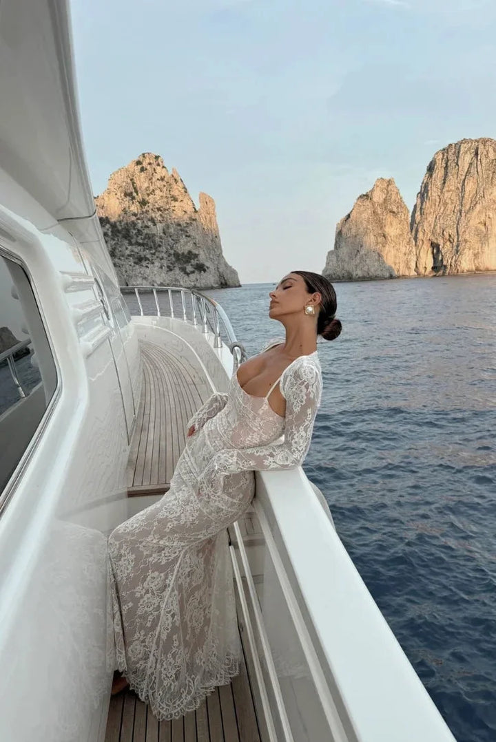 White fitted lace dress with sheer sleeves, elegantly crafted with delicate lace and elegant sheer detailing.