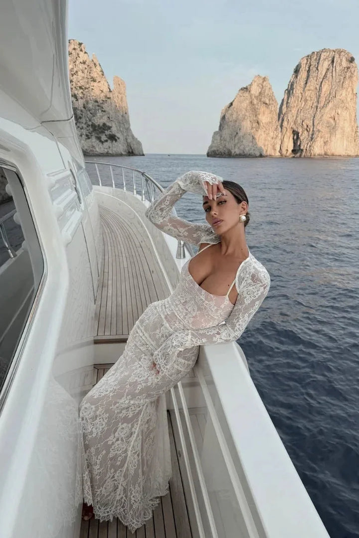White fitted lace dress with sheer sleeves, perfect for an elegant look.