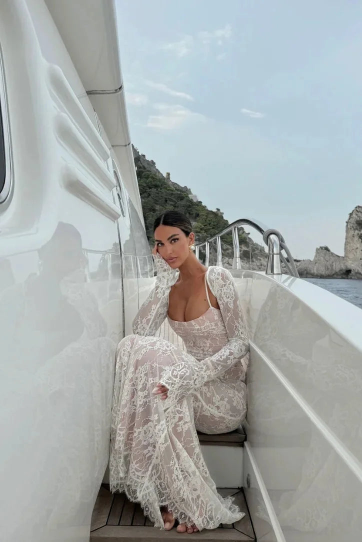 White lace dress featuring a fitted silhouette and sheer sleeves: Lillyann exudes elegance and sophistication.