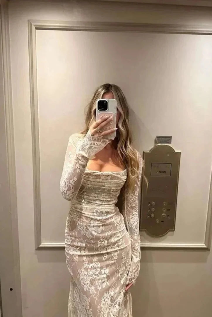 White fitted lace dress with sheer sleeves for a chic and elegant look ideal for special occasions or events.