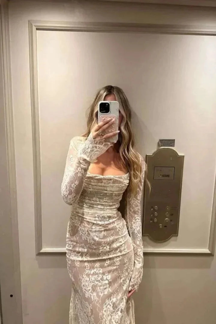 White fitted lace dress with sheer sleeves for a chic and elegant look ideal for special occasions or events.