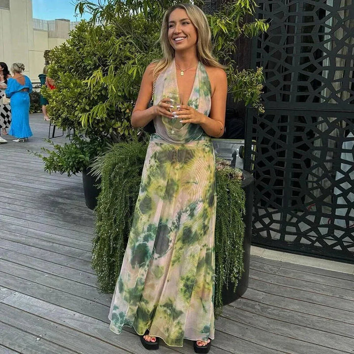 Green tie-dye halter maxi dress, perfect for casual summer days. Made with comfortable and breezy fabric.
