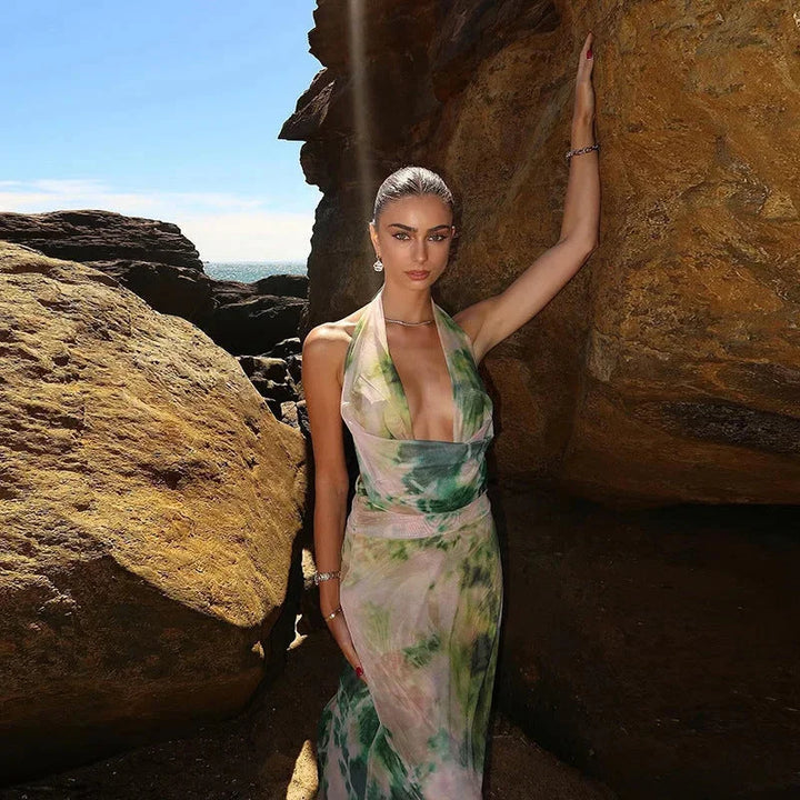 Green tie-dye maxi dress with halter neckline, perfect for outdoor events in a lightweight and flowy fabric.