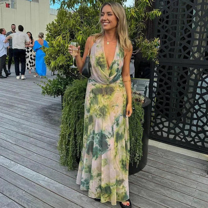 Green tie-dye maxi dress with halter neckline, perfect for summer. Made of lightweight, flowy fabric for a comfortable and…
