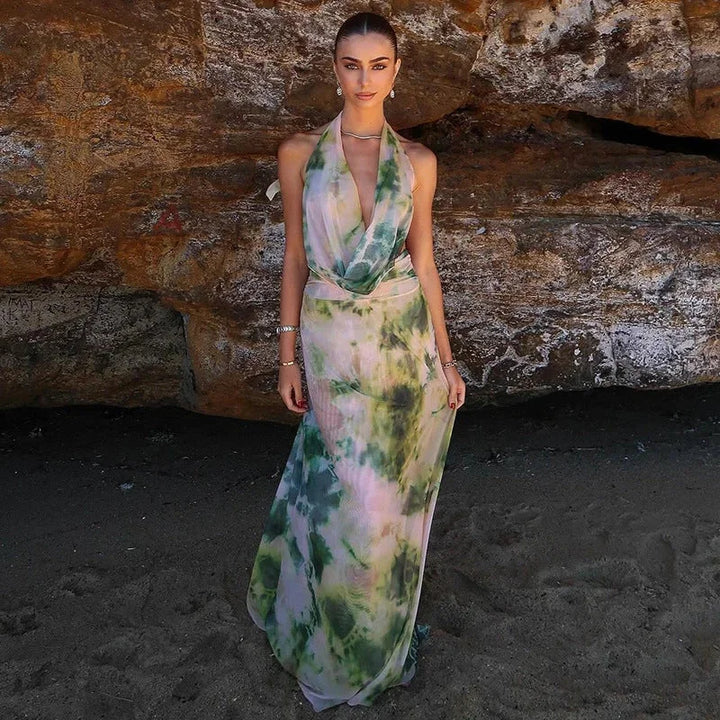 "Green tie-dye maxi dress with halter neckline, perfect for a boho chic look, made from lightweight and flowy fabric."
