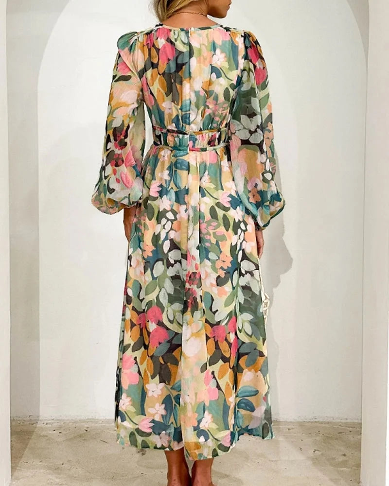 Flowy floral maxi dress with belt in soft chiffon featuring a vintage-inspired floral pattern in shades of blue and pink.