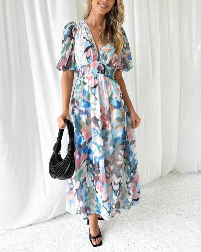 Blue floral maxi dress made from flowy fabric with a belt accessory. Feminine and stylish design ideal for casual or…