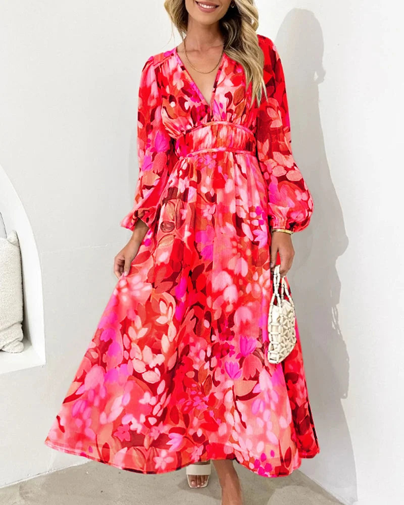 Flowy red maxi dress with floral pattern, includes a belt. Lightweight material, ideal for summer days.