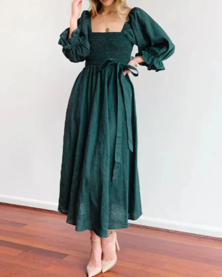 "Women's wrap dress in black with ruched sleeves, made from soft and breathable fabric. Flattering fit for versatile…