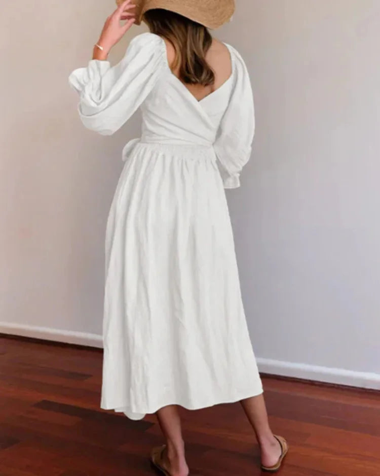 "Black wrap dress for women with ruched sleeves, made of soft cotton-poly blend, perfect for casual and formal occasions."