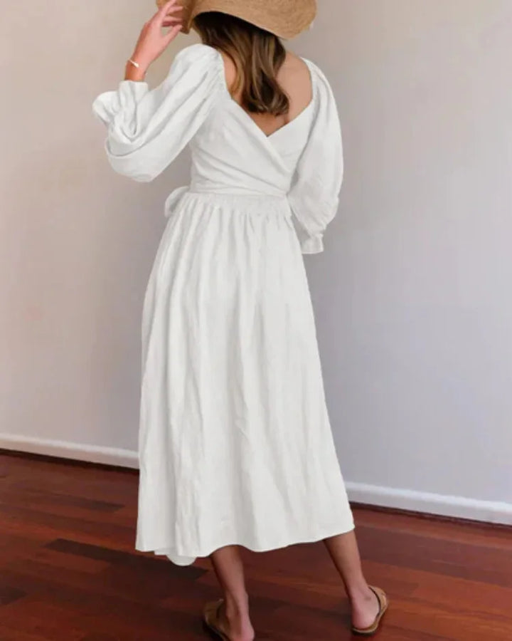 "Black wrap dress for women with ruched sleeves, made of soft cotton-poly blend, perfect for casual and formal occasions."