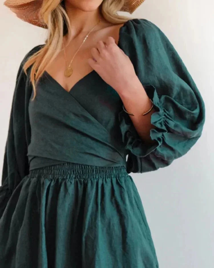 "Black wrap dress with ruched sleeves made of soft, breathable fabric for women's wear."