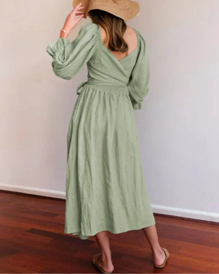 "Black wrap dress with ruched sleeves, V-neck, and waist tie, perfect for a casual-chic look"