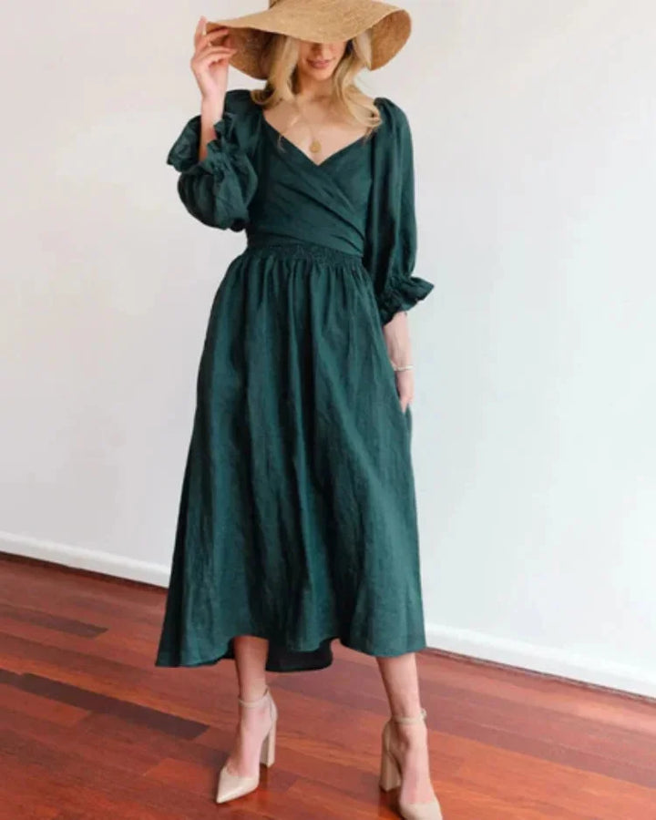"Dark green wrap dress with ruched sleeves for women. Features a flattering design and comfortable material."