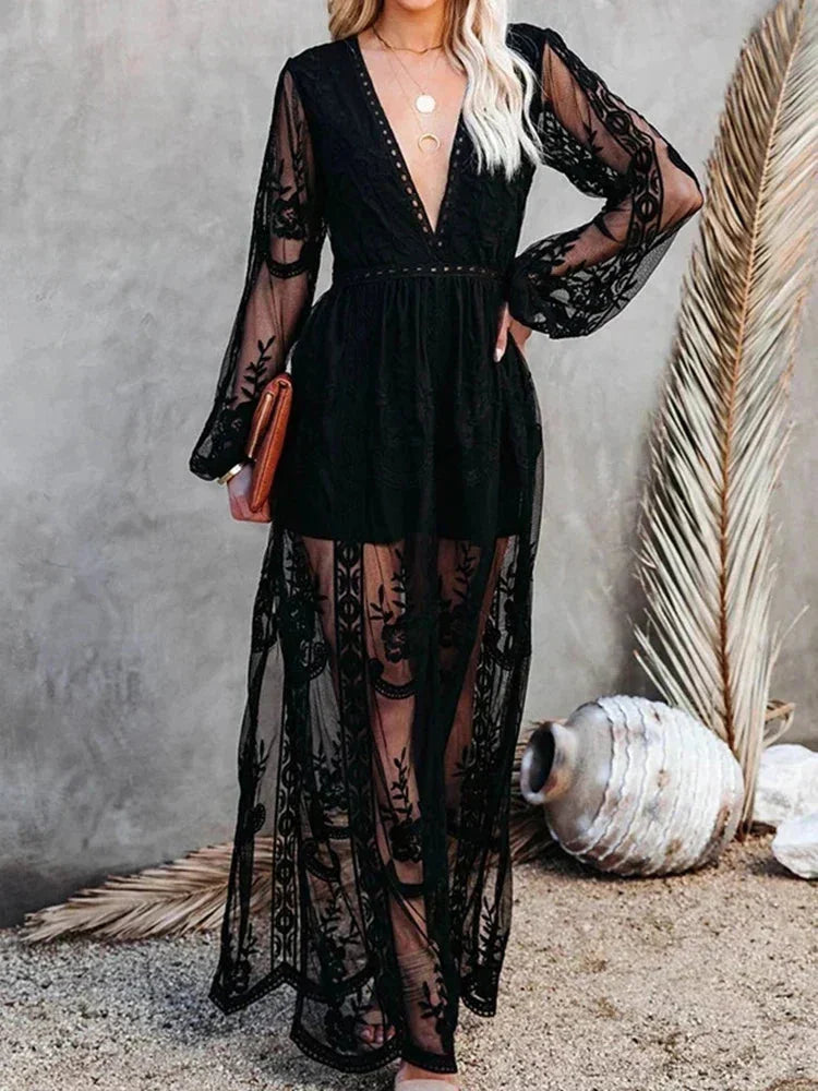 Black long sleeve dress with sheer lace detailing. Elegant and sophisticated design perfect for a special occasion.