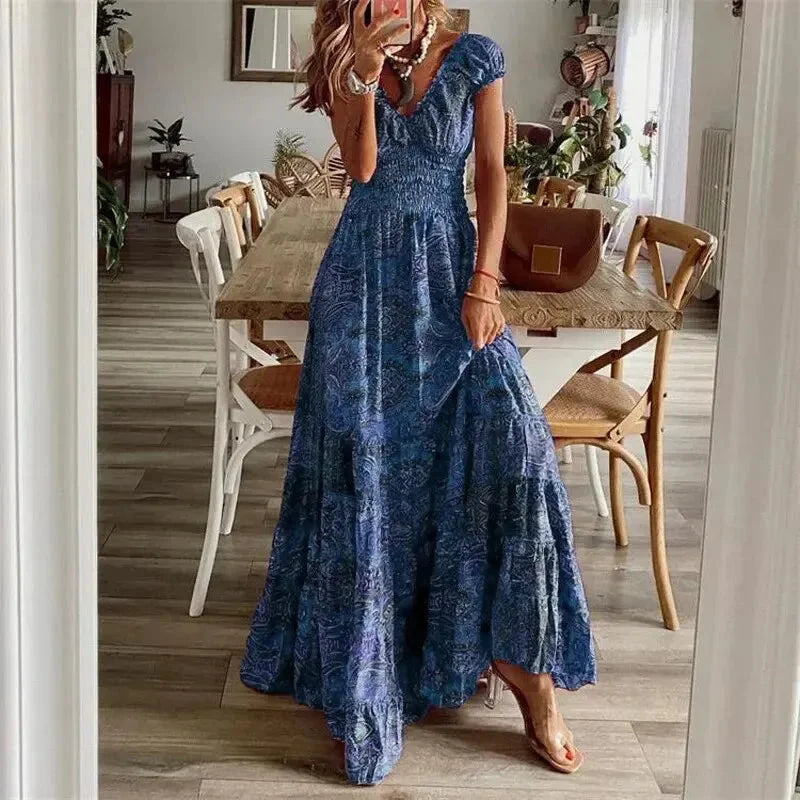 Blue V-neck tiered maxi boho dress, made of soft flowing fabric with intricate embroidery detailing, perfect for a laid-back…