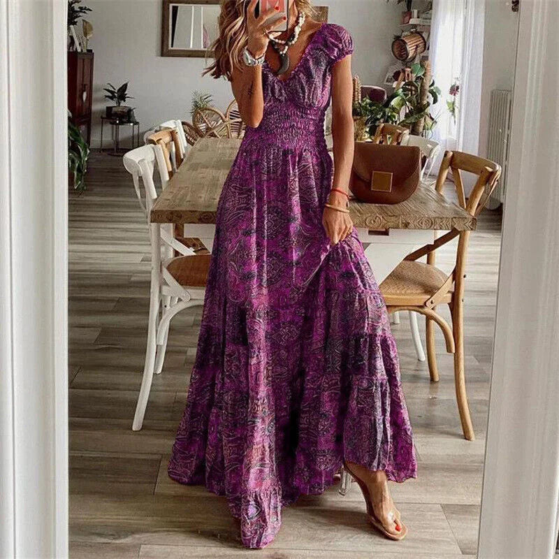 Purple V-neck maxi dress with tiered design and boho style. Made of flowing fabric, perfect for casual occasions or summer…