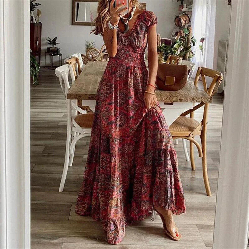 Red V-neck tiered maxi boho dress made of lightweight cotton blend with intricate floral embroidery detail.