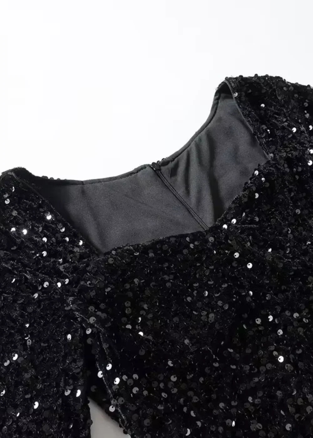 "Black mini dress featuring shimmering sequins and chic puff sleeves by Maevery."