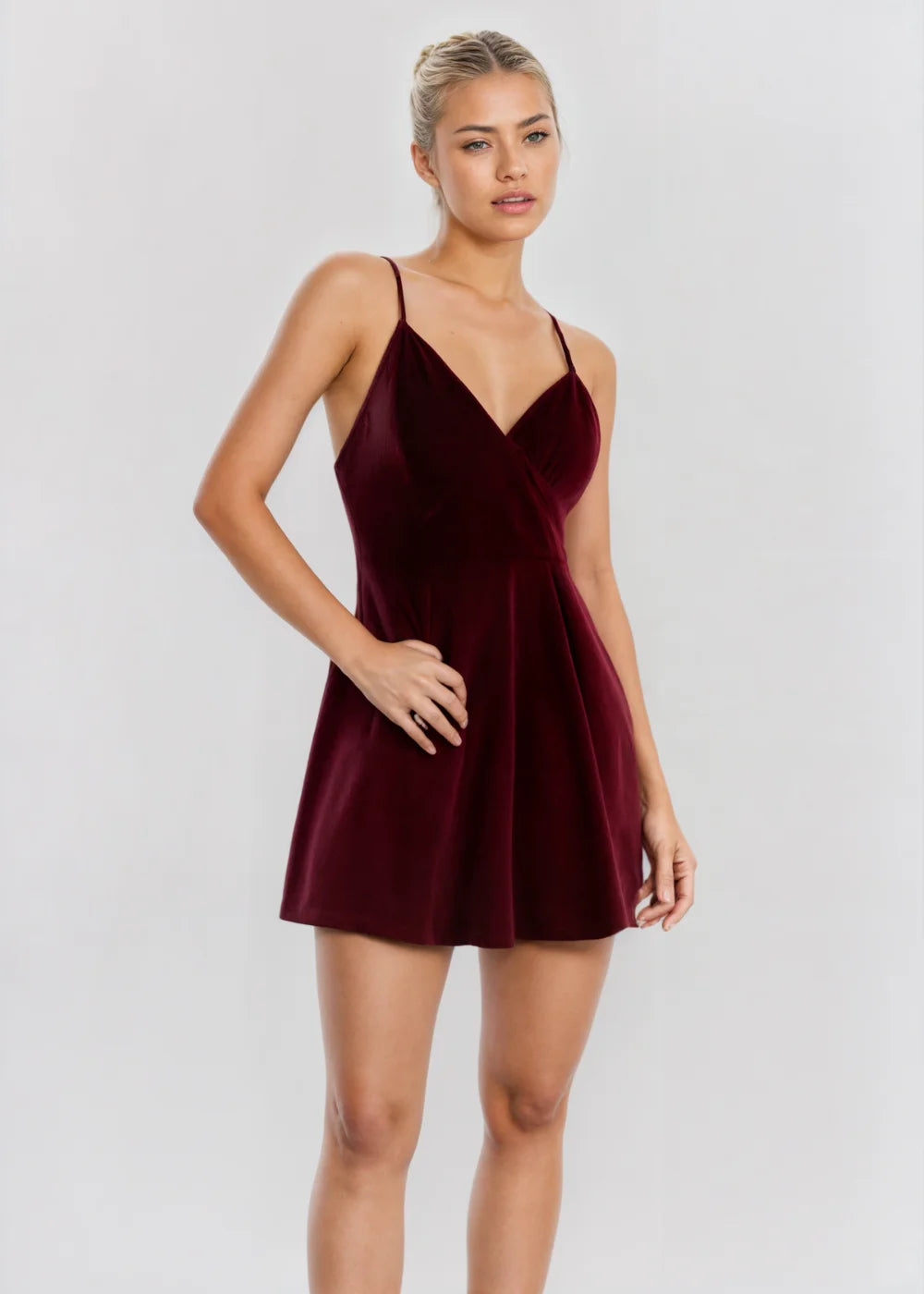 Burgundy skater mini dress with sleeveless design, made of elegant fabric and featuring a flattering silhouette for a chic…