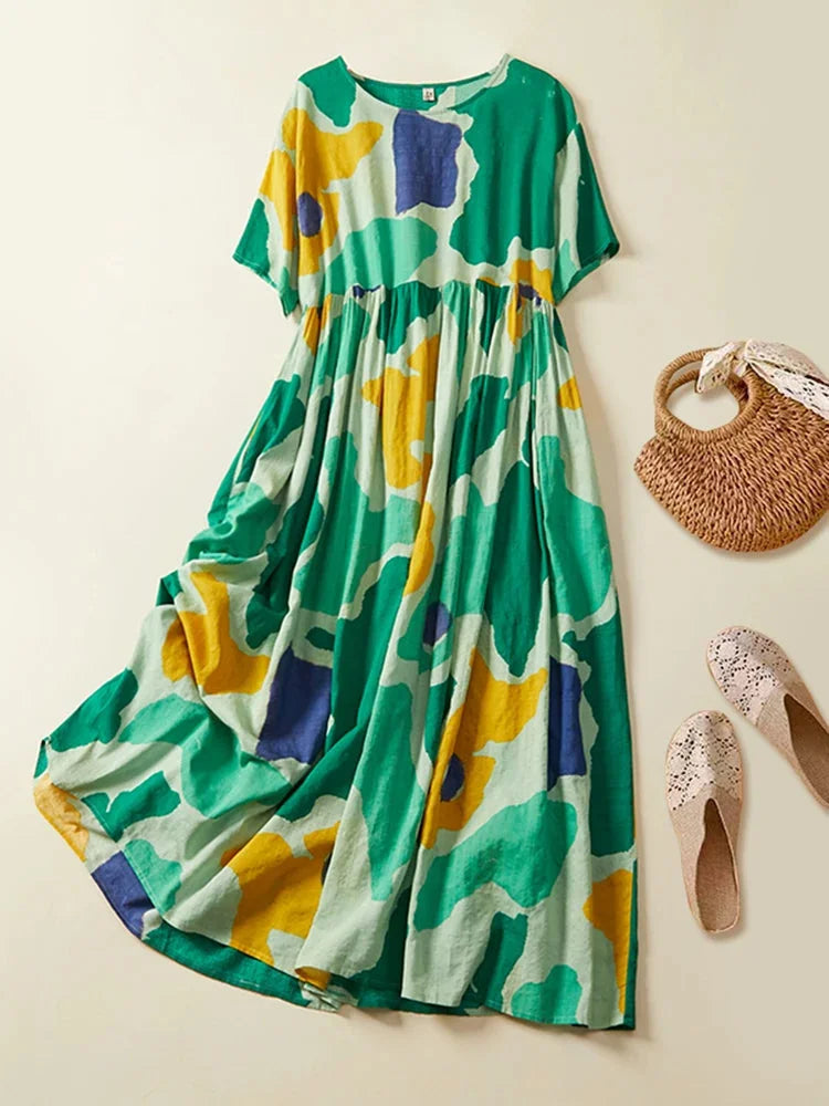 Flowy green maxi dress with abstract print design, made from lightweight fabric. Perfect for a casual yet stylish look.