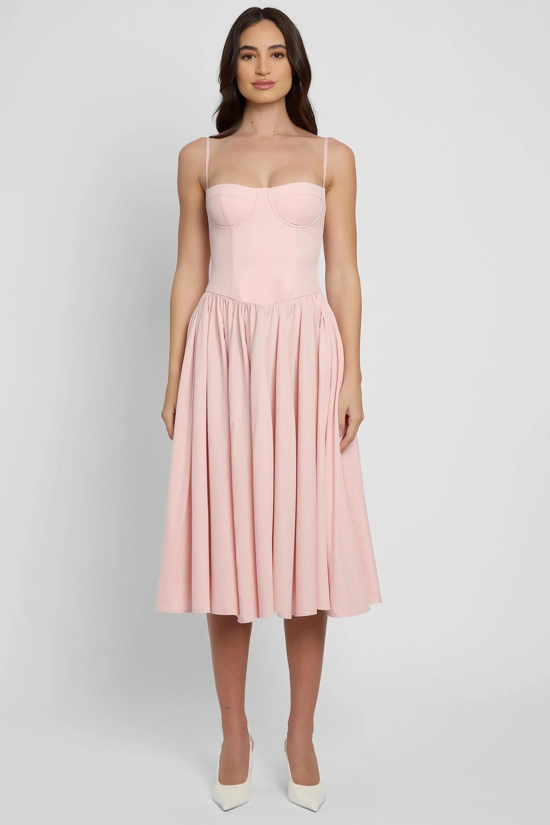 Pink mid-length bustier dress with pleated skirt, made of lightweight chiffon fabric. Features delicate pleats and a…