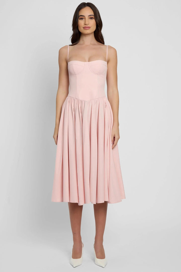 Pink mid-length bustier dress with pleated skirt, made of lightweight chiffon fabric. Features delicate pleats and a…