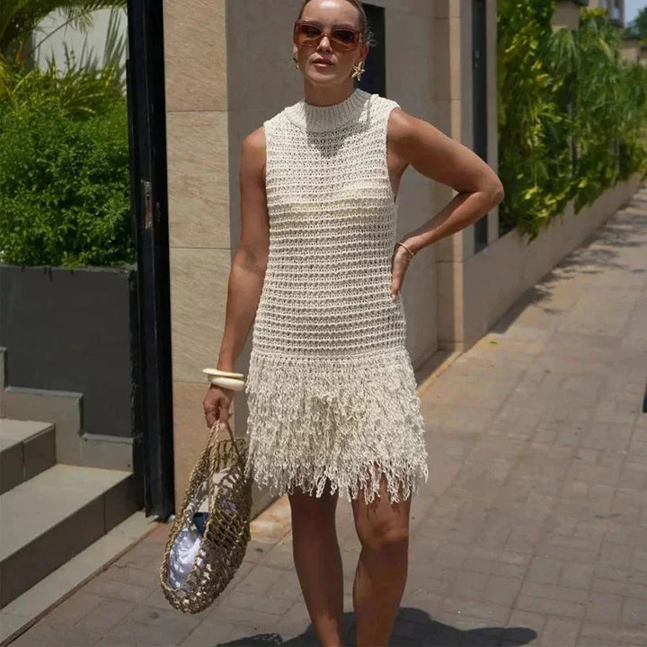 Ivory sleeveless ankle-length dress with tassels, light and airy fabric, adorned with stylish tassels at the hem.