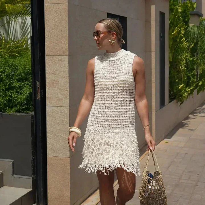Ivory ankle-length dress with tassels, sleeveless design in lightweight fabric.