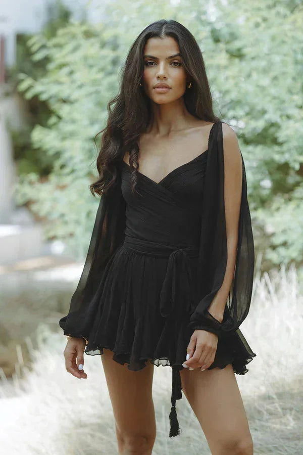 Black mini dress with draped design and ruffled hem, perfect for a stylish and elegant look.