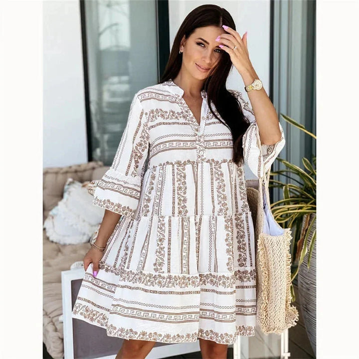 Brown v-neck mini dress with tiered design and flared sleeves. Made from lightweight fabric, perfect for casual or dressy…
