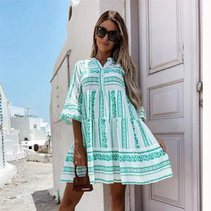 Green v-neck mini dress with tiered design and flared sleeves. Made from lightweight, comfortable fabric ideal for casual or…