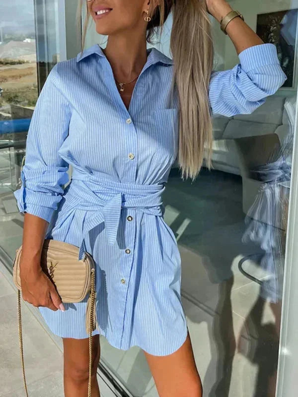 Blue shirt dress with rolled sleeves, belted waist, and stylish design. Made with high-quality fabric for a chic look.