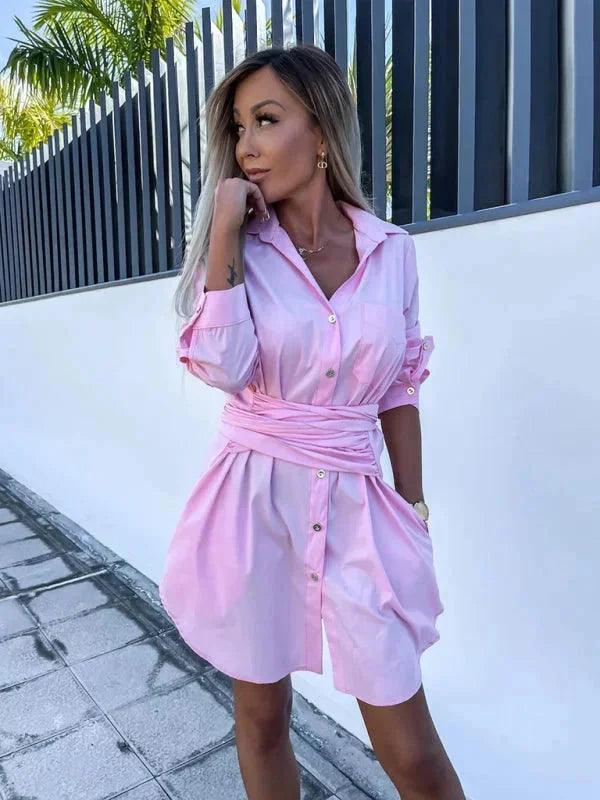 Pink belted shirt dress with rolled sleeves in a cotton blend fabric. Stylish and versatile design, perfect for everyday…