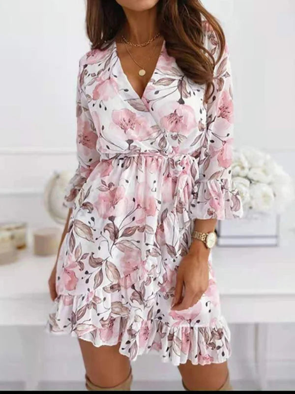 Floral mini dress with tie-waist feature. Summery design in a breezy fabric perfect for casual outings.