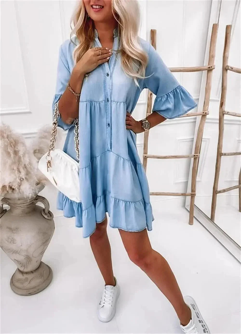 Light blue denim dress with layered ruffles, perfect for a casual yet trendy look. Ideal for sunny days and outings.