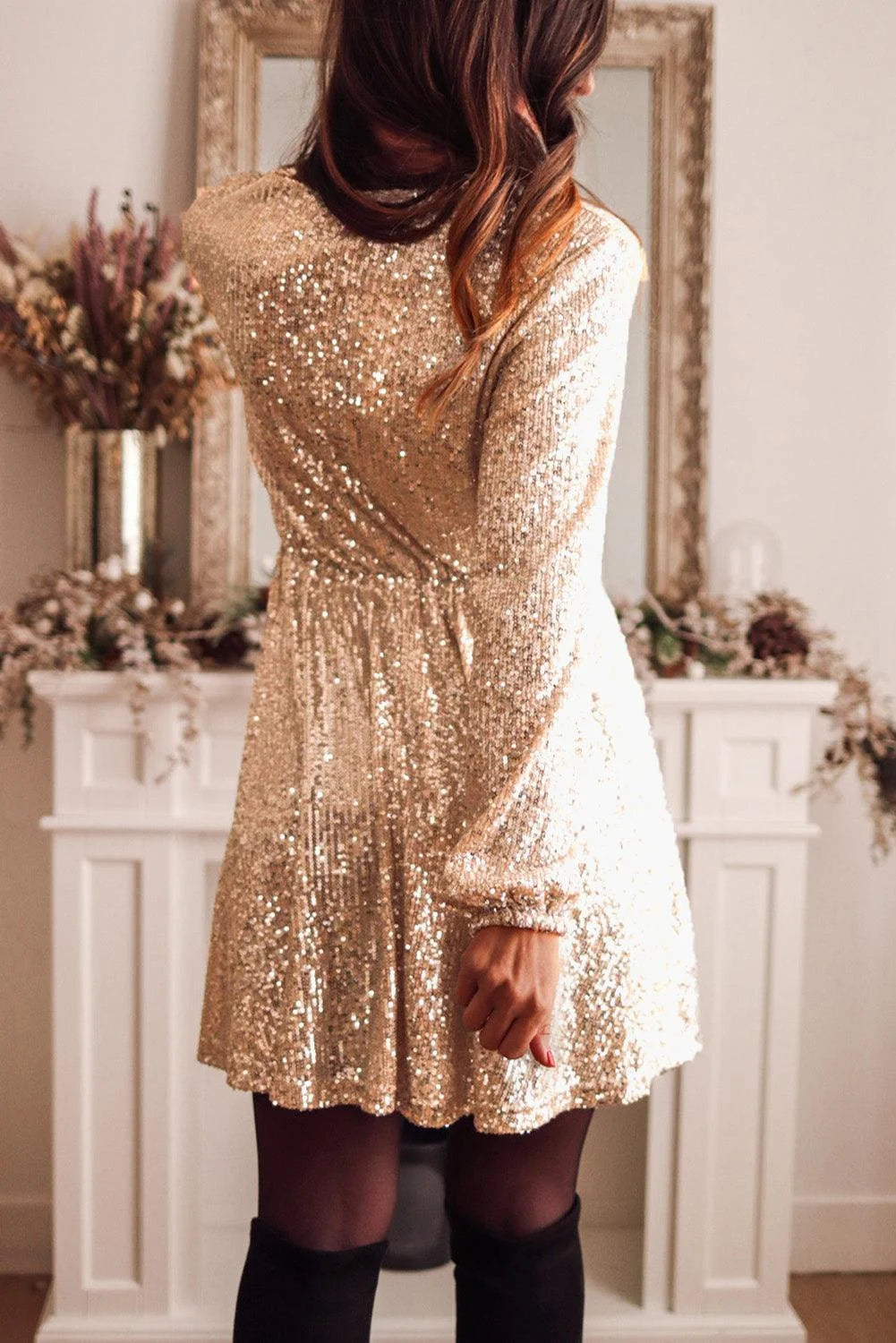 Gold sequin mini dress with long sleeves, perfect for shimmering nights out. Eye-catching design with glamorous sequins for…