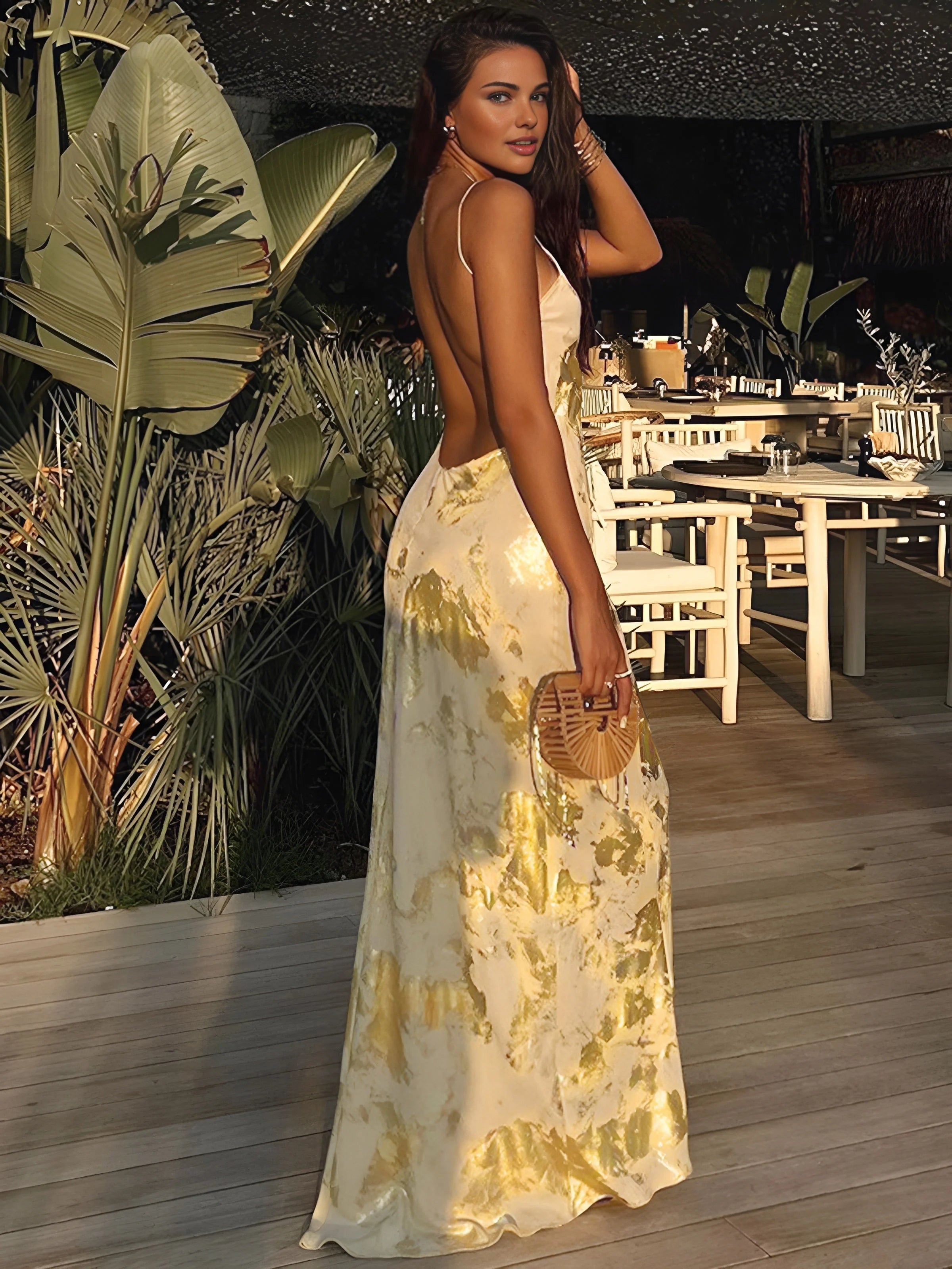 Gold foil detailed maxi dress with a flowy silhouette and ornate design, perfect for special occasions.