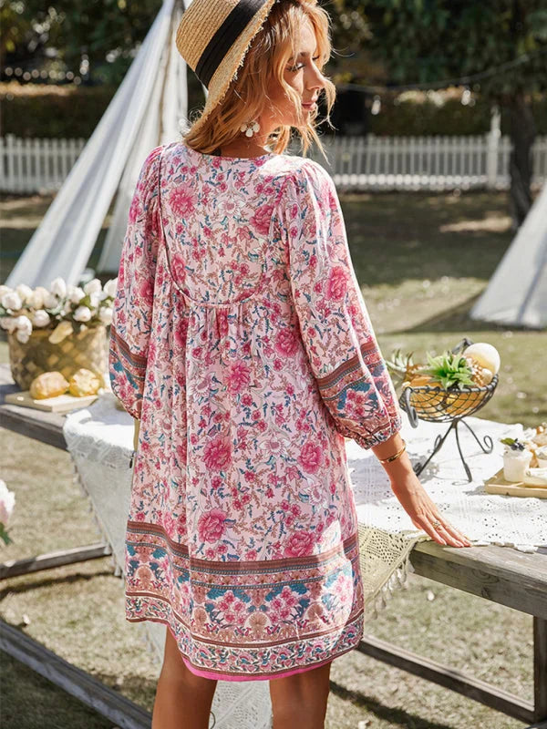 Flowy bohemian mini dress with floral patterns made from lightweight fabric, perfect for a relaxed and casual summer look.