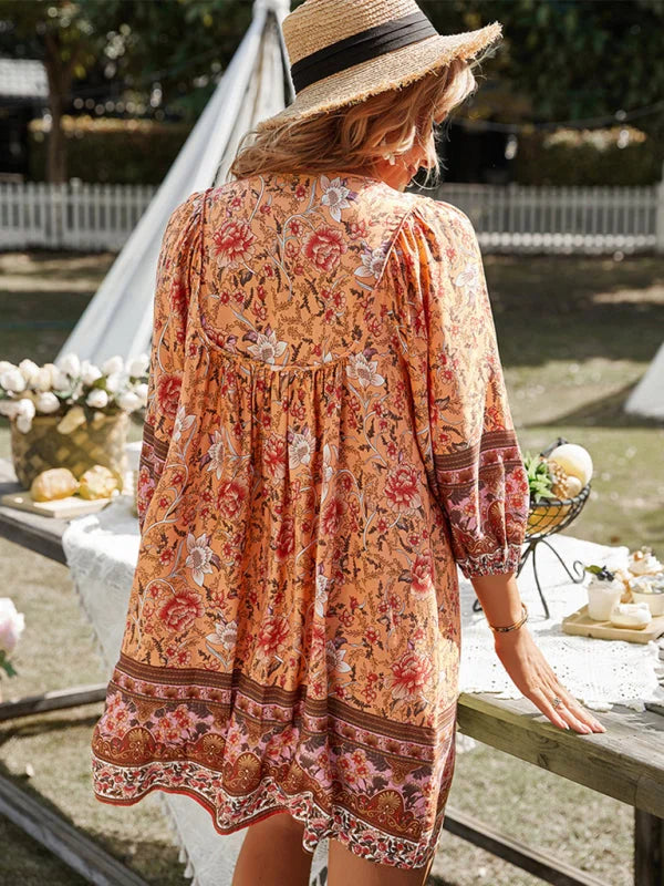 Flowy bohemian mini dress with floral patterns in soft fabric, perfect for a casual and feminine look.