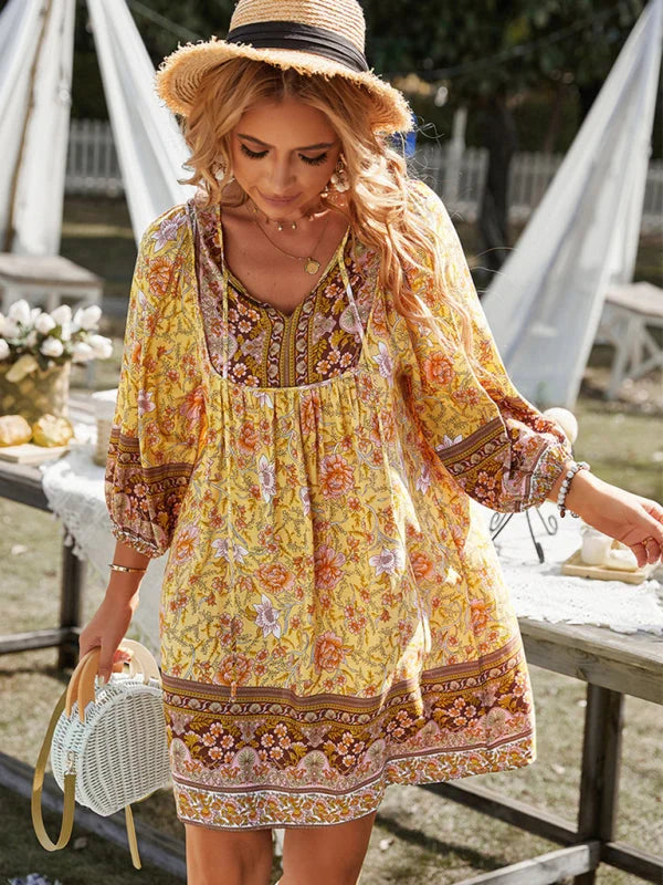 "Yellow flowy bohemian mini dress with floral patterns, perfect for a playful and vibrant look. Light, airy material for a…