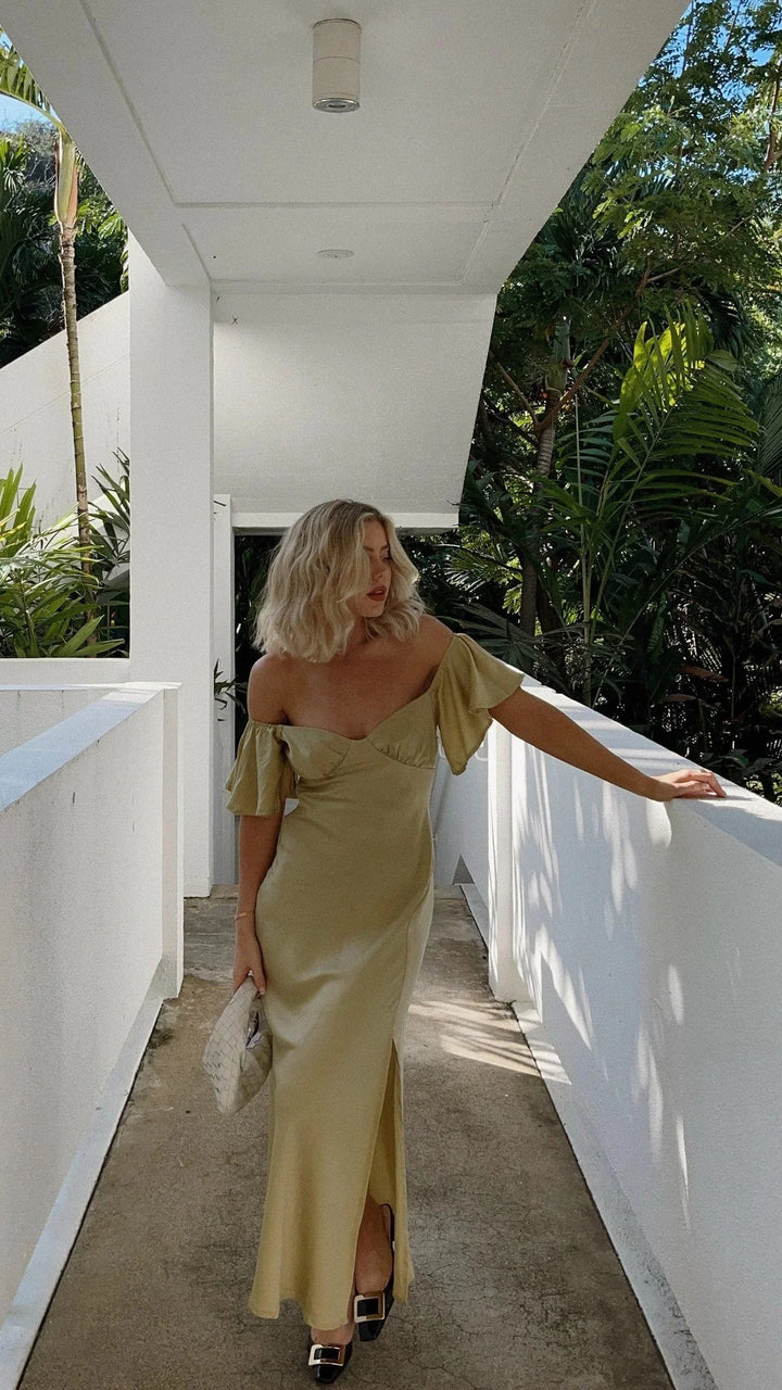 Off-shoulder maxi dress with slits, made from breathable fabric. Stylish design perfect for a chic and elegant look.