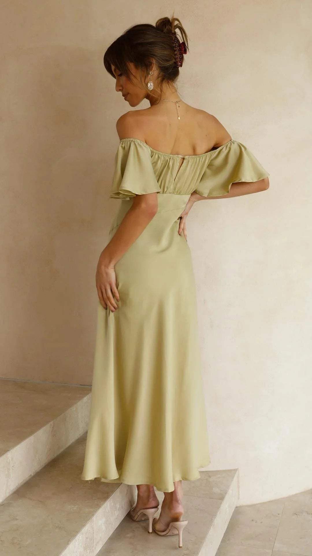 Off-shoulder maxi dress with slits, made with flowy fabric. Stylish design adds a touch of elegance to your outfit.