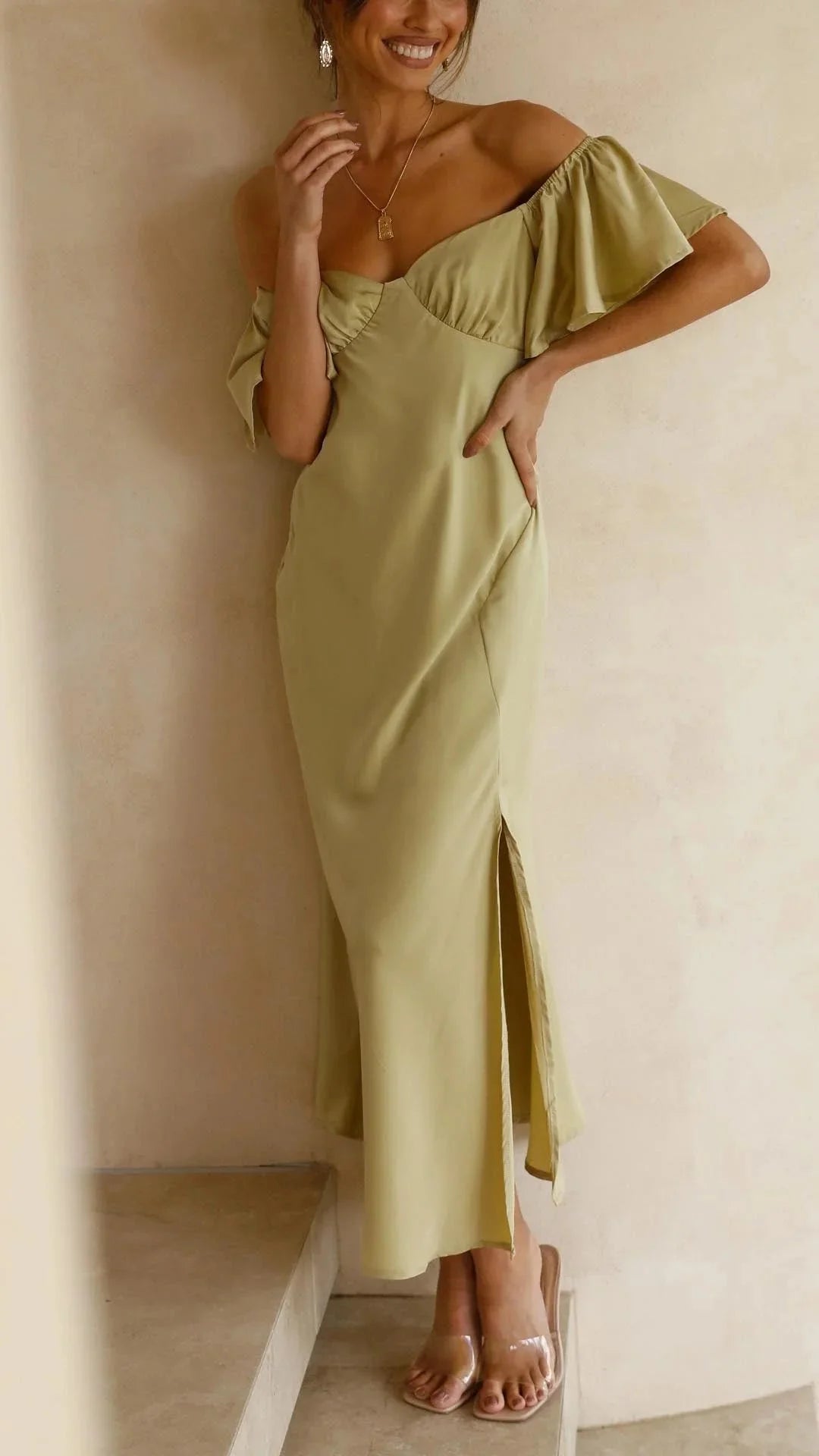 Off-shoulder maxi dress in black with elegant slits, perfect for a chic yet sophisticated look.