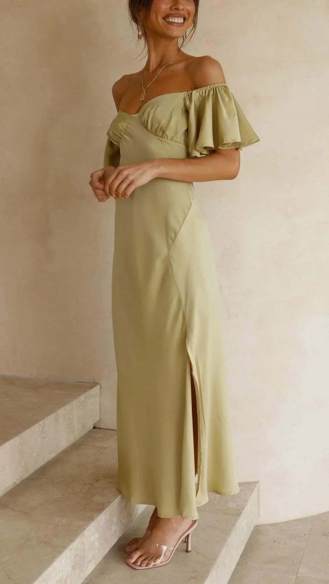 Off-shoulder maxi dress in flowy fabric with elegant slits design.