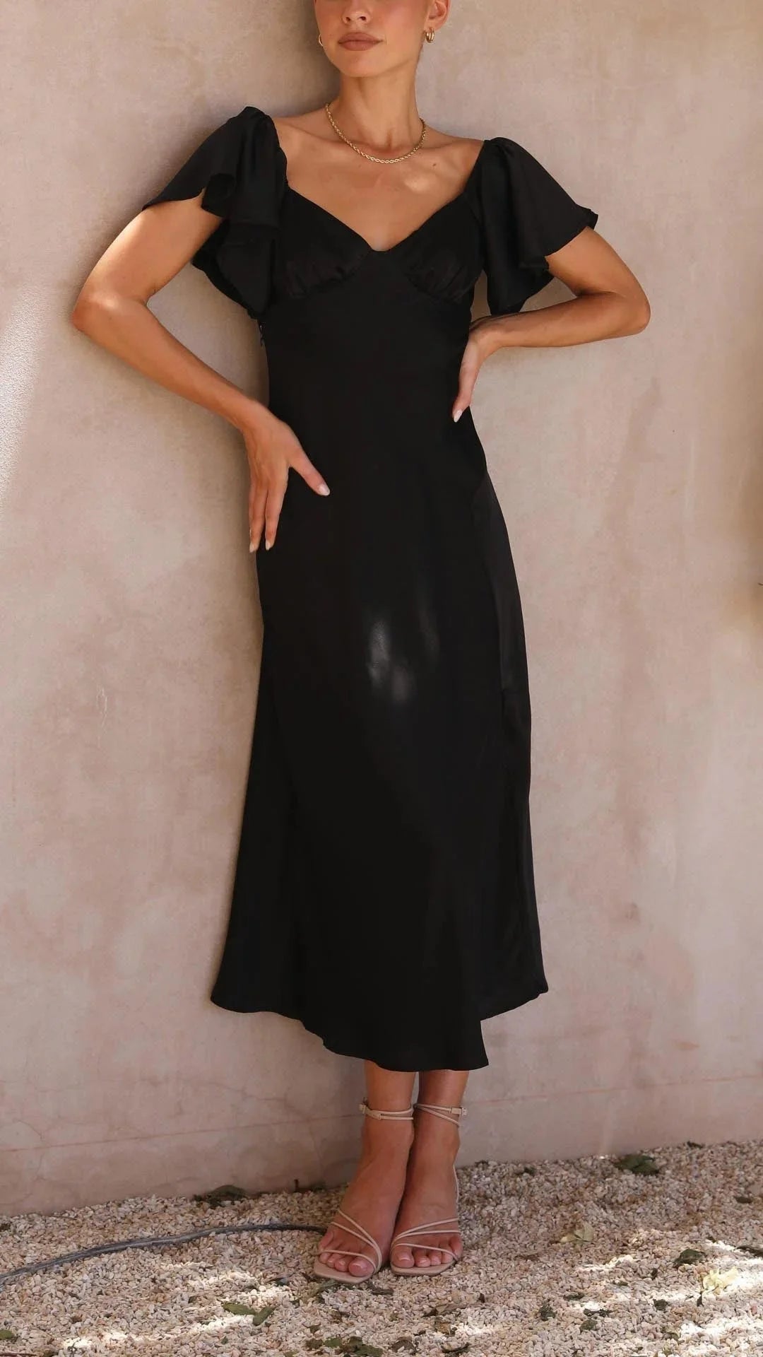 "Black off-shoulder maxi dress with elegant slits featuring a flowy design, perfect for a sophisticated occasion or night…