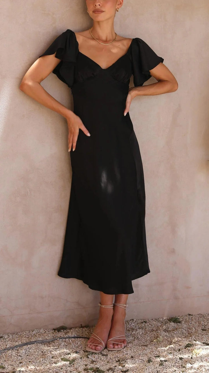 "Black off-shoulder maxi dress with elegant slits featuring a flowy design, perfect for a sophisticated occasion or night…