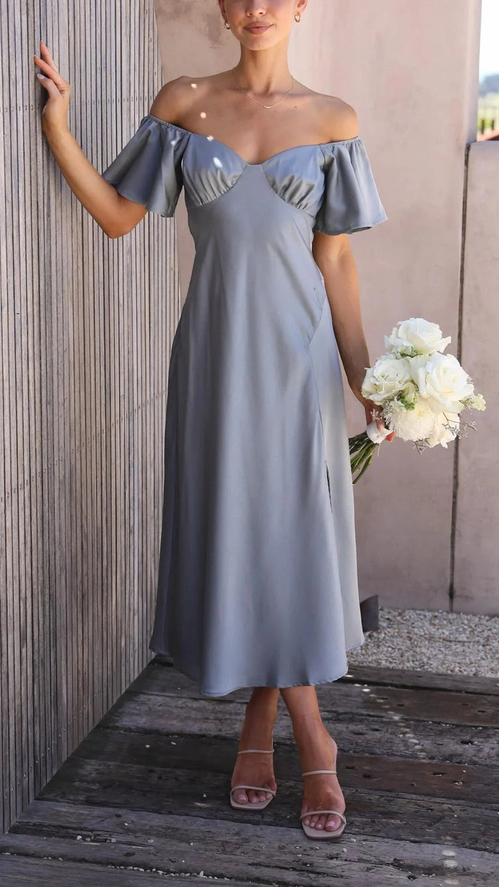 Blue off-shoulder maxi dress with elegant slits, made from soft and flowy fabric. Perfect for a stylish and sophisticated…