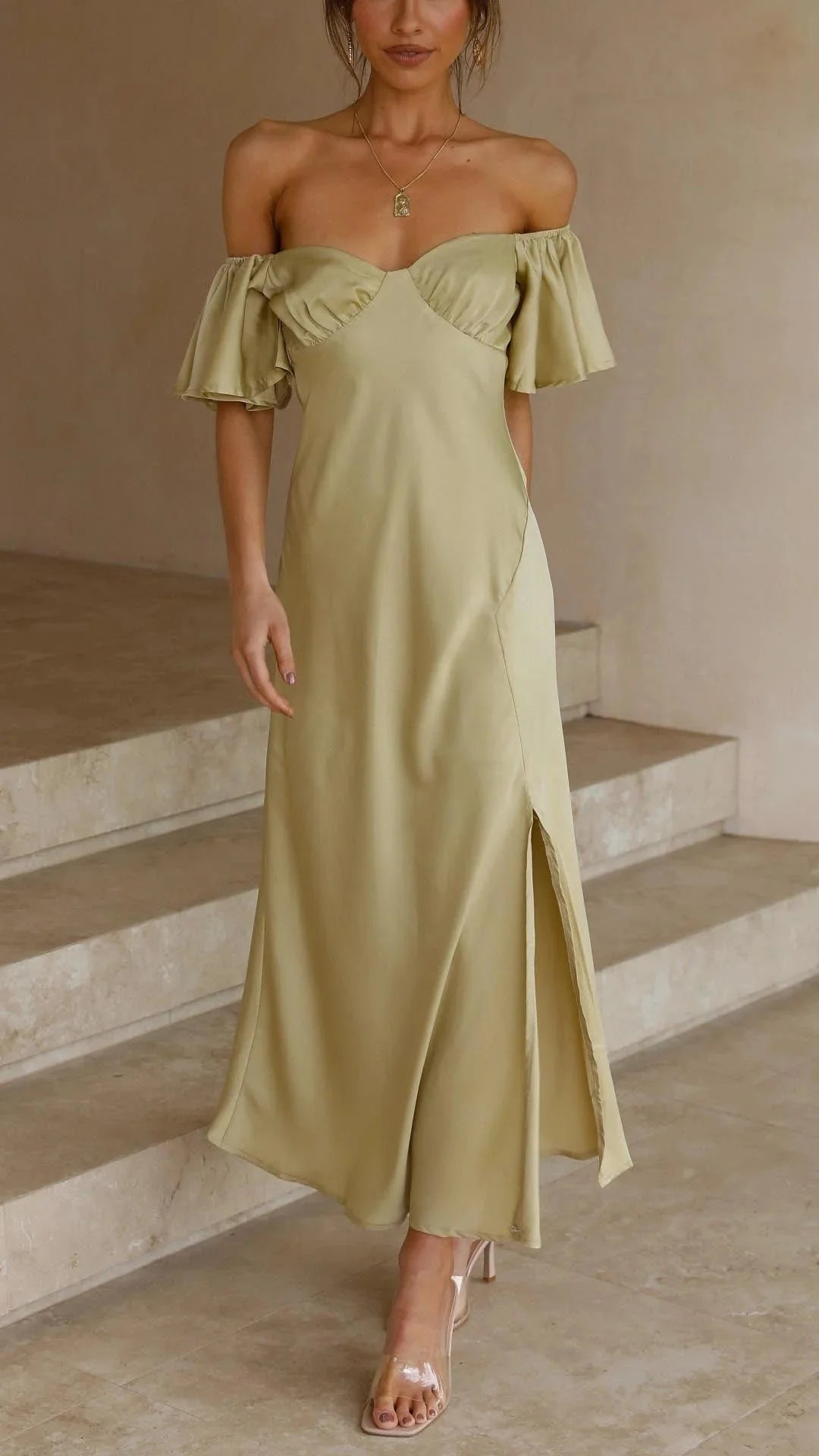 Olive off-shoulder maxi dress with slits, tailored with soft and flowing fabric for a stylish and elegant look.